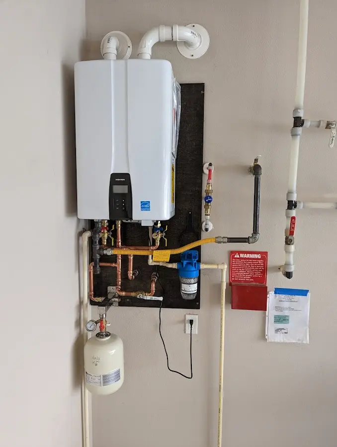 Professional plumber installing copper piping in a Lake Barrington home